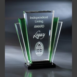 Crystal trophy with green accents, etched “Independent Living Award Legacy” and house logo on black base, for corporate recognition.