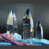 Vetri crystal awards with blue-tinted tops, ideal for corporate recognition or milestone achievements, displayed on blue cloth.