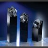 Set of geometric crystal trophy awards on black pedestals, ideal for corporate recognition or employee achievements.