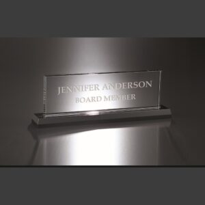 Crystal nameplate award engraved with Jennifer Anderson, Board Member, on reflective surface for corporate recognition.