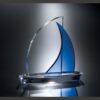 Crystal sailboat trophy with clear base and blue accent, ideal for corporate recognition or employee achievement awards.