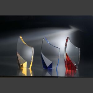 Crystal trophy awards with clear tops and colored bases, ideal for corporate or employee recognition, on reflective surface.
