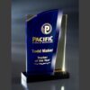 Blue and gold crystal trophy featuring "Pacific Steel & Recycling, Todd Maker, Trucker of the Year" corporate achievement.