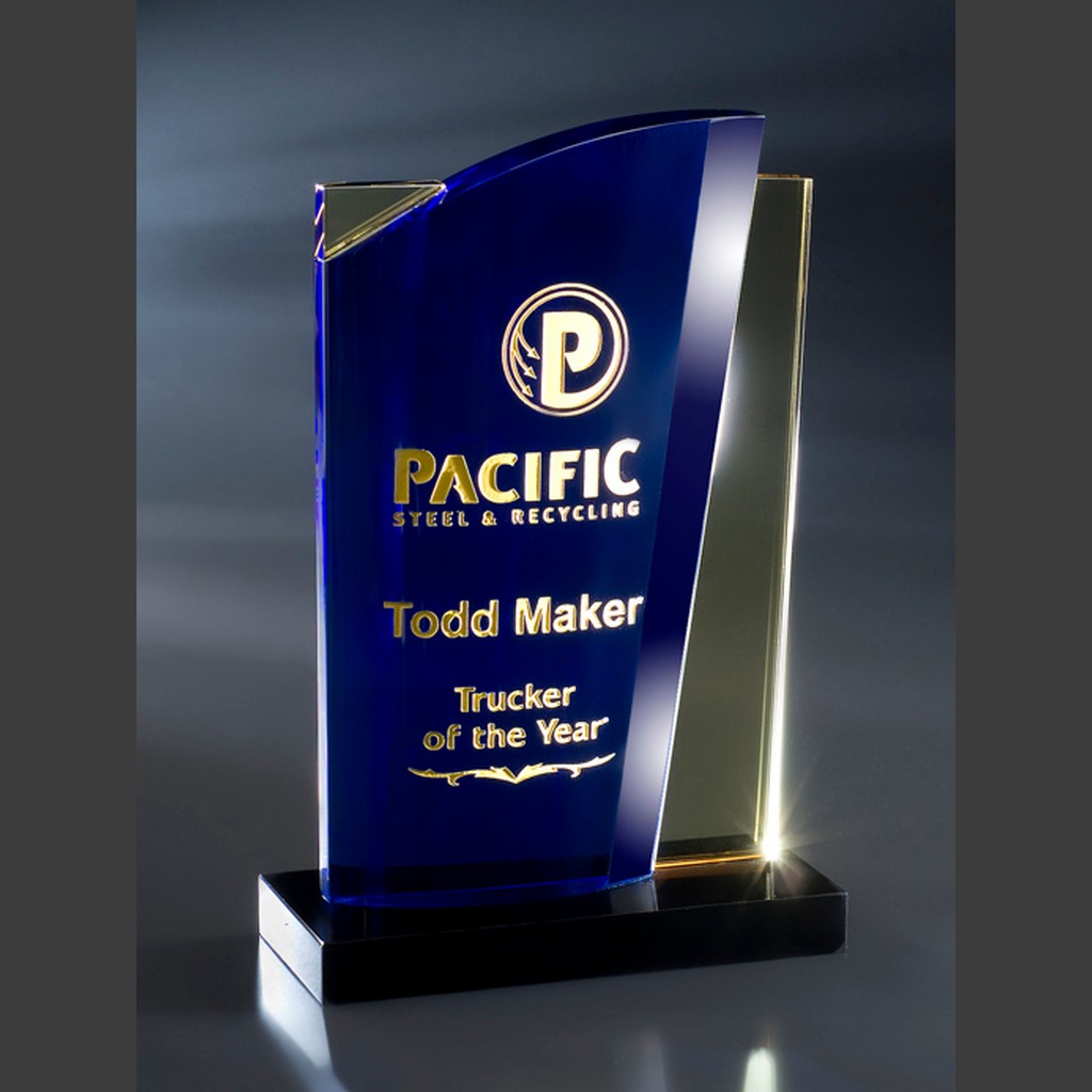 Blue and gold crystal trophy featuring "Pacific Steel & Recycling, Todd Maker, Trucker of the Year" corporate achievement.