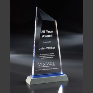 Crystal triangular award on gray base, engraved for 25 years of service recognition; ideal corporate milestone trophy.
