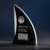 Black crystal sail-shaped trophy with water logo, honoring Specialist of the Year for corporate achievement.