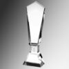 Clear crystal trophy with faceted sides and wide base, ideal for corporate or employee recognition, on gray gradient background.